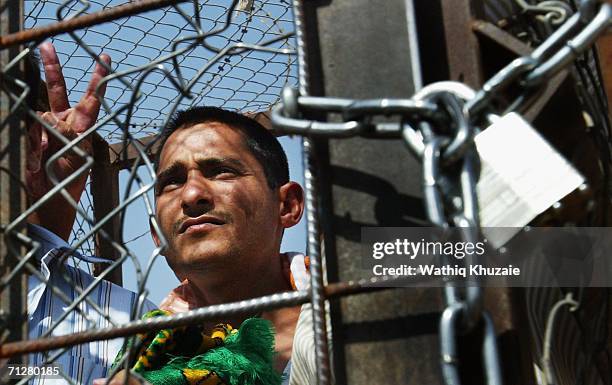 An Iraqi prisoner waves as he waits to be released on June 23, 2006 at Abu Ghraib prison west of Baghdad, Iraq. More than 500 Iraqi detainees were...