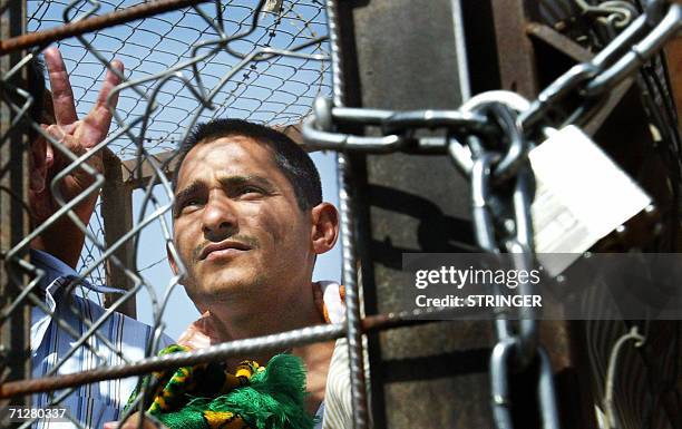An Iraqi prisoner flashes the "V" sign as he waits to be released 23 June 2006 at Abu Ghraib prison west of Baghdad. Iraq released 500 detainees from...