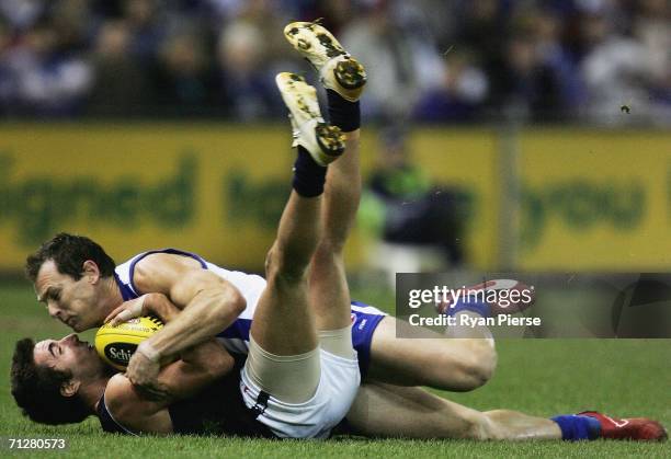 Adam Simpson of the Kangaroos tackles Kade Simpson of the Blues during the round twelve AFL match between the Kangaroos and Carlton Blues at the...