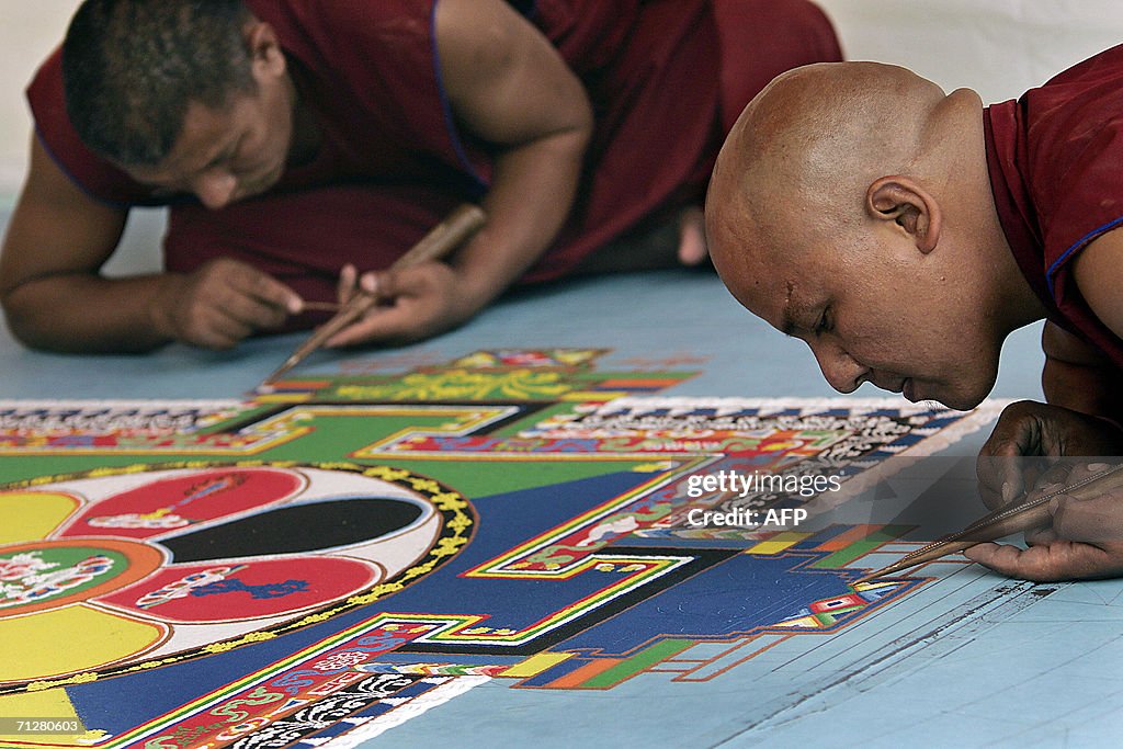 Tibetan monks work on a mandala, part of