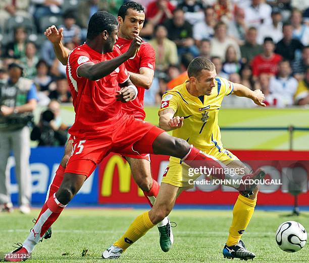 Ukrainian forward Andriy Shevchenko is challenged by Tunisian defender Radhi Jaidi and midfielder Jawhar Mnari in the opening round Group H World Cup...