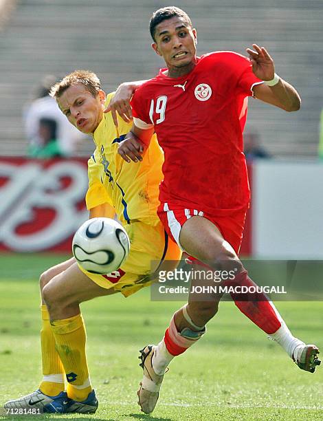 Ukrainian midfielder Oleg Gusev vies with Tunisian defender Anis Ayari in the opening round Group H World Cup football match Ukraine vs. Tunisia, 23...