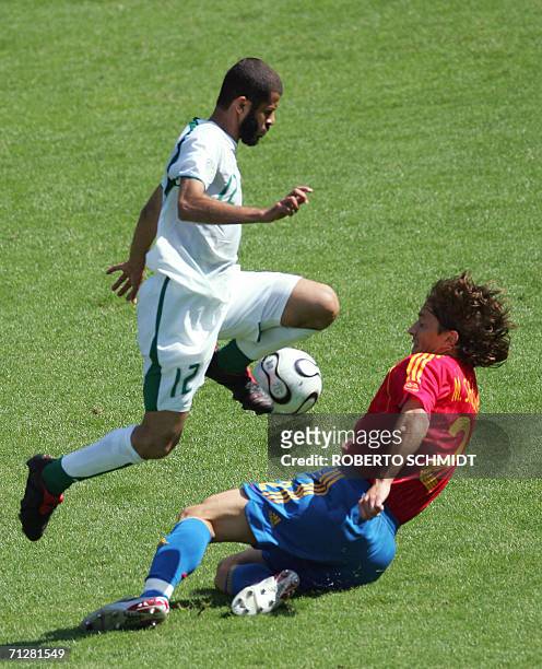 Kaiserslautern, GERMANY: Saudi defender Abdulaziz Khathran is challenged by Spanish defender Michel Salgado during the opening round Group H World...