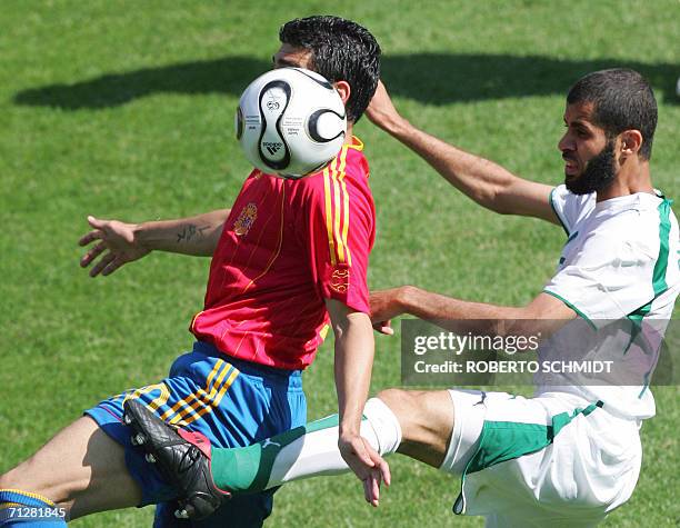 Kaiserslautern, GERMANY: Saudi defender Abdulaziz Khathran fights for the ball with Spanish midfielder Jose Antonio Reyes during the opening round...