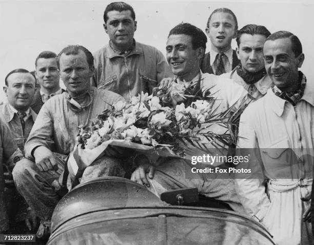 Eugene Chaboud and Jean Tremoulet of France, drivers of the Delahaye 135CS celebrate winning the World Sportscar Championship 24 Hours of Le Mans...