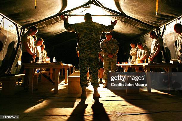 Army Chaplain Cpt. Tim Thompson says the benediction after a prayer service for American soldiers at a U.S. Base June 23, 2006 near Deh Afghan in the...