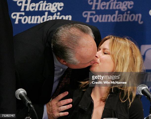 Radio personality Rush Limbaugh kisses actress Mary Lynn Rajskub before the start of a panel discussion "'24' and America's Image in Fighting...