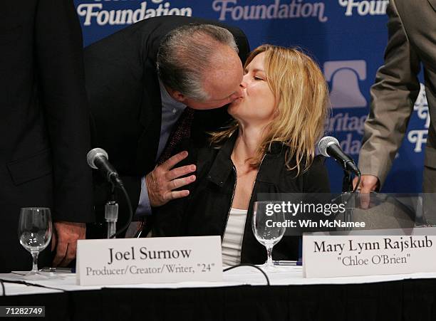 Radio personality Rush Limbaugh kisses actress Mary Lynn Rajskub before the start of a panel discussion "'24' and America's Image in Fighting...