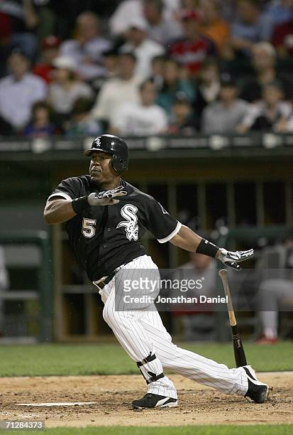 Juan Uribe of the Chicago White Sox makes a hit during the game against the St. Louis Cardinals on June 20, 2006 at U.S. Cellular Field in Chicago,...