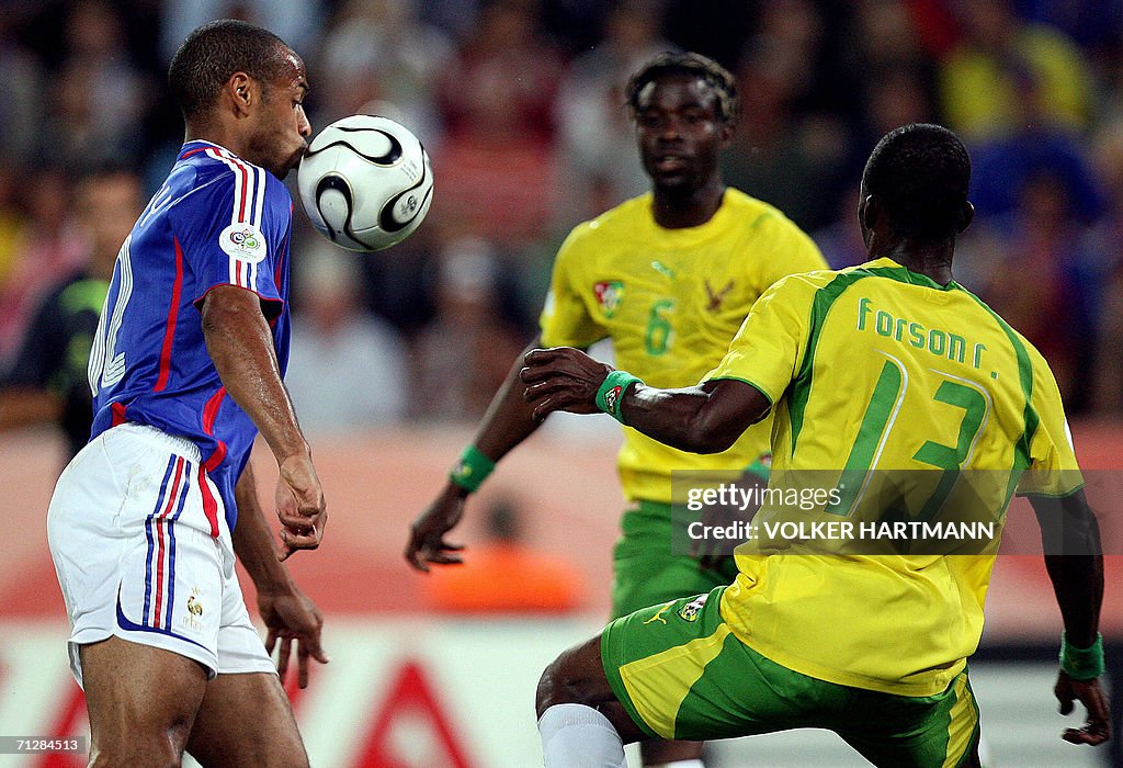 French forward Thierry Henry fights for