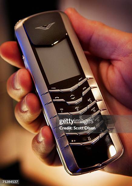 Nokia employee shows off the company's Vertu Signature wireless phone at the Nokia Flagship Store during an opening preview prior to the store's...