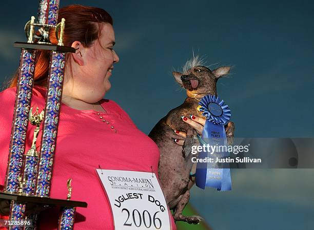 Heather Peoples of Phoenix, Arizona holds her Chinese Crested dog Archie after he was crowned the World's Ugliest Dog at the 18th annual World's...