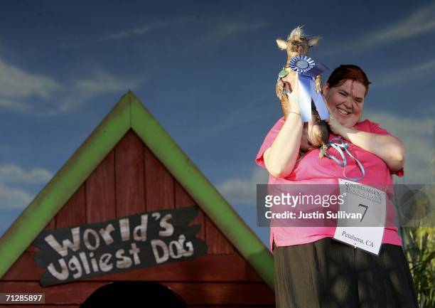 Heather Peoples of Phoenix, Arizona holds her Chinese Crested dog Archie after he was crowned the World's Ugliest Dog at the 18th annual World's...