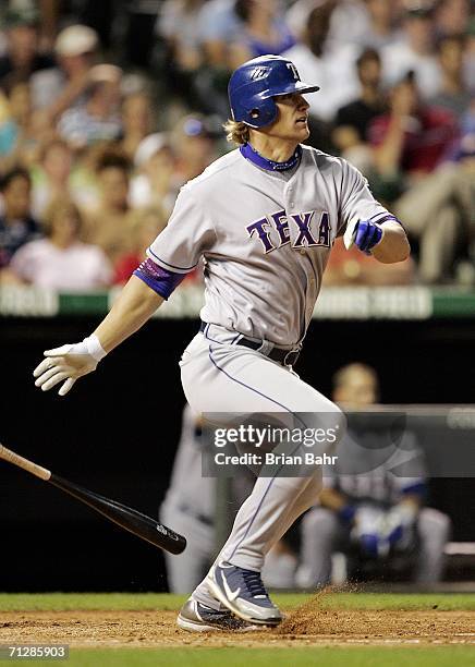 Pinch hitter Jason Botts of the Texas Rangers turns on an RBI single to put the Rangers ahead of the Colorado Rockies in the sixth inning on June 23,...