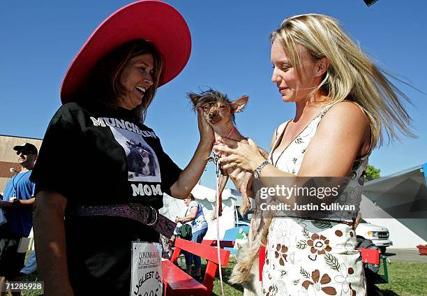 Yvonne Morones pets a dog named Lucielle Bald is seen during the 18th annual World's Ugliest Dog competition June 23, 2006 at the Sonoma-Marin Fair...