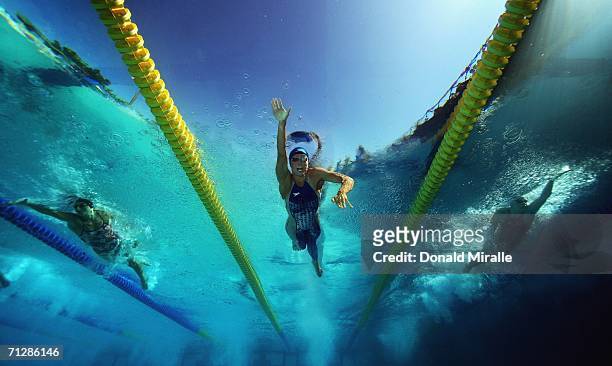 Natalie Coughlin of the USA swims to win in the Women's 100M Freestyle Final as her teammate Erin Reilly and Mary Descenza swim behind during the...