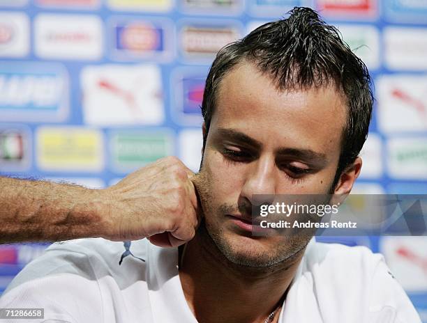 Alberto Gilardino has his cheek pulled by team doctor Enrico Castellacci during an Italy National Football Team press conference on June 24, 2006 in...