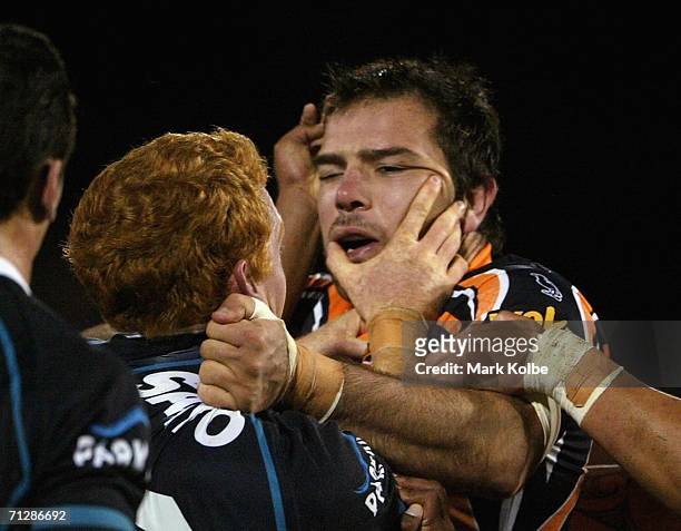 Luke Swain of the Panthers and John Skandalis of the Wests Tigers scuffle during the round 16 NRL match between the Penrith Panthers and the Wests...