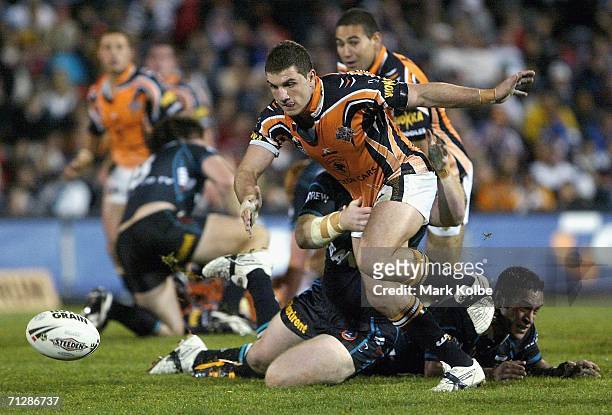 Robbie Farah of the Wests Tigers is tackled without the ball during the round 16 NRL match between the Penrith Panthers and the Wests Tigers at CUA...