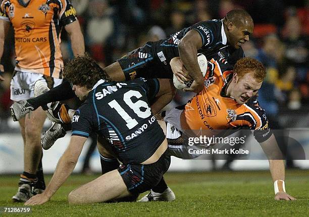 Keith Galloway of the Wests Tigers is tackled during the round 16 NRL match between the Penrith Panthers and the Wests Tigers at CUA Stadium June 24,...