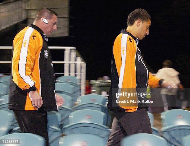 Benji Marshall of the West Tigers leaves the stadium with his arm under his jacket in a sling after being injured during the round 16 NRL match...