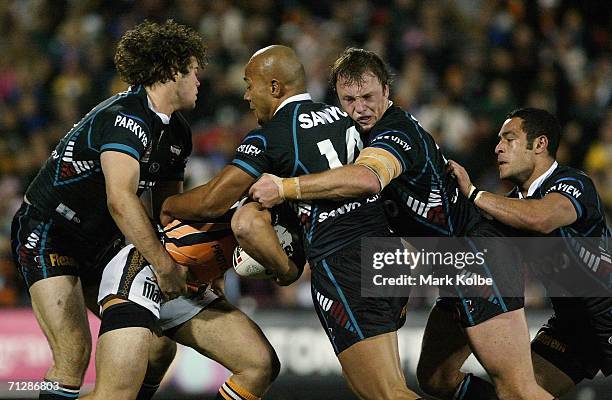 The Panthers defence muscles up during the round 16 NRL match between the Penrith Panthers and the Wests Tigers at CUA Stadium June 24, 2006 in...
