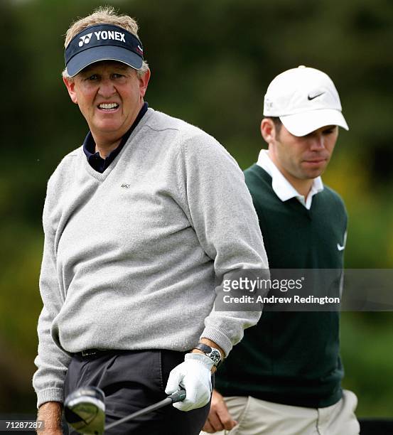 Colin Montgomerie of Scotland watches his tee-shot on the eighth hole as Paul Casey of England stands by during the third round of The Johnnie Walker...