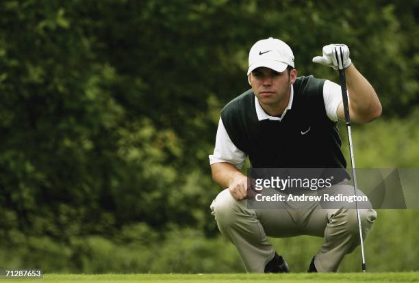 Paul Casey of England lines up his chip on the fifth hole during the third round of The Johnnie Walker Championship on The PGA Centenary Course at...