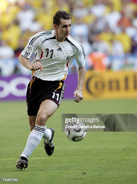 Miroslav Klose of Germany runs with the ball during the FIFA World Cup Germany 2006 Round of 16 match between Germany and Sweden at the Stadium...