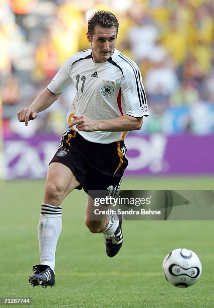 Miroslav Klose of Germany runs with the ball during the FIFA World Cup Germany 2006 Round of 16 match between Germany and Sweden at the Stadium...