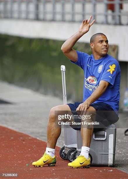 Ronaldo of Brazil waves as he sits on a box of drinks during the Brazil National Football Team training session for the FIFA World Cup Germany 2006...
