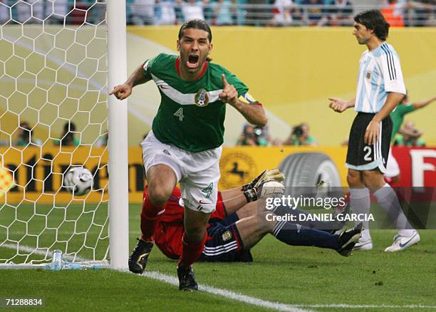 Mexican defender Rafael Marquez celebrates scoring next to Argentinian goalkeeper Roberto Abbondanzieri the opening goal during the World Cup 2006...