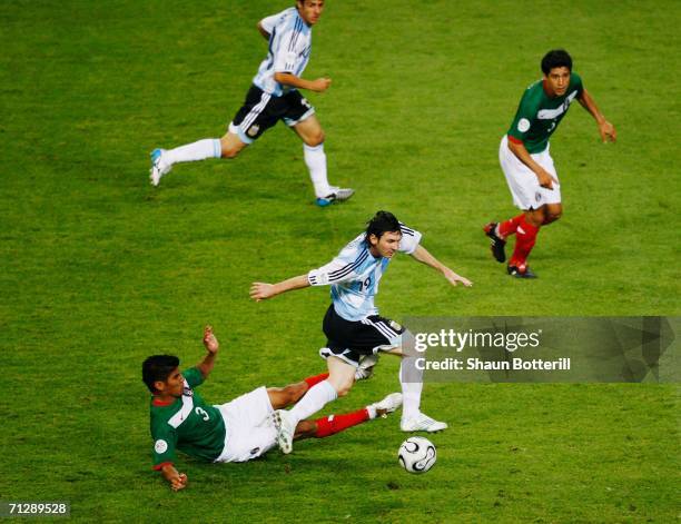 Lionel Messi of Argentina is tackled by Carlos Salcido of Mexico during the FIFA World Cup Germany 2006 Round of 16 match between Argentina and...