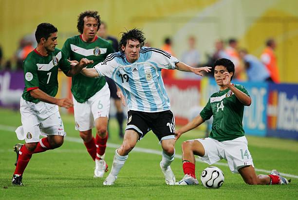 Lionel Messi of Argentina is put under pressure by Zinha, Gerardo Torrado and Gonzalo Pineda of Mexico during the FIFA World Cup Germany 2006 Round...