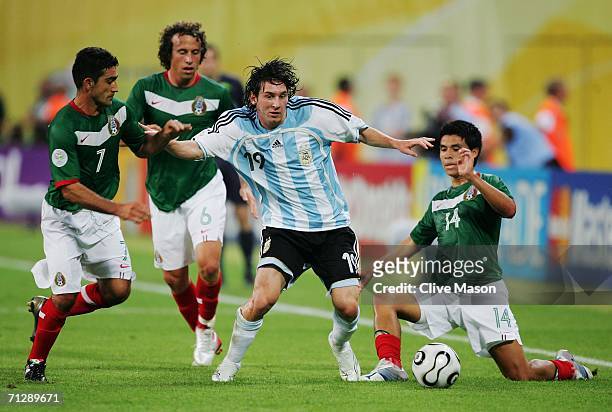 Lionel Messi of Argentina is put under pressure by Zinha, Gerardo Torrado and Gonzalo Pineda of Mexico during the FIFA World Cup Germany 2006 Round...