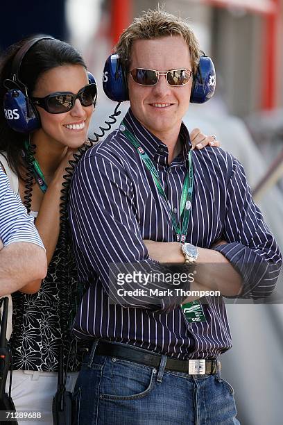 English golfer Luke Donald and fiance Diane Antonopoulos talk during the practice secession for the Canadian Formula One Grand Prix at the...