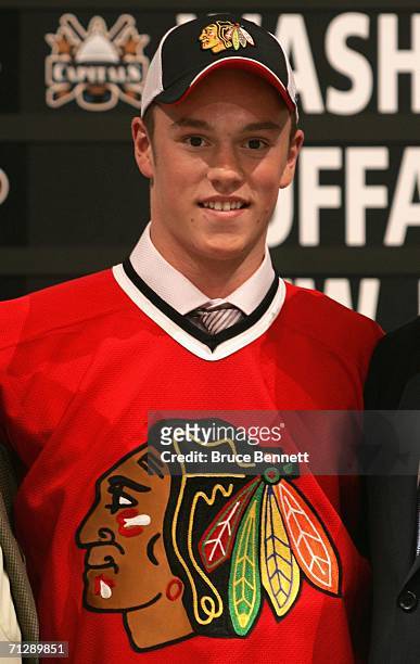 3rd overall pick Jonathan Toews of the Chicago Blackhawks poses on stage during the 2006 NHL Draft held at General Motors Place on June 24, 2006 in...