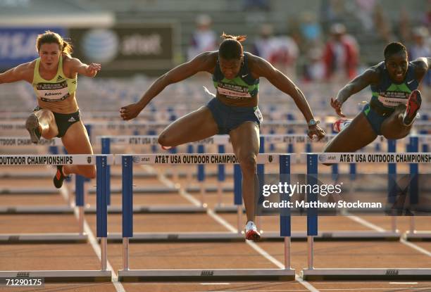 Virginia Powell leads Damu Cherry and Jenny Adams over the last hurdle on her way to winning the women's 100 meter hurdle final on the third day of...