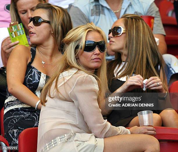 Colleen McLoughlin , the girlfriend of English forward Wayne Rooney, and Elen Rives , the girlfriend of English midfielder Frank Lampard sit together...