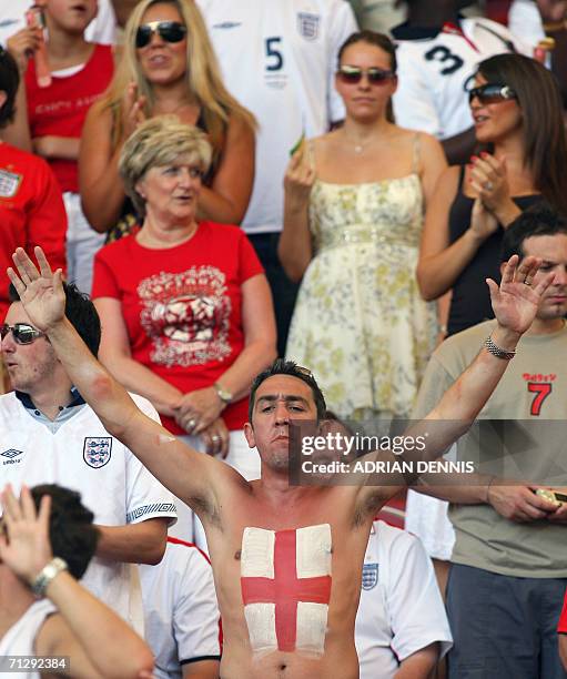 An England fan cheers as Rebecca Ellison , longtime partner of English defender Rio Ferdinand, the mother of English midfielder David Beckham, Sandra...