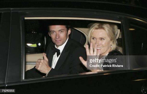 Actors Hugh Jackman and his wife Deborra-Lee Furness leave the party after the wedding of actress Nicole Kidman and musician Keith Urban at St...