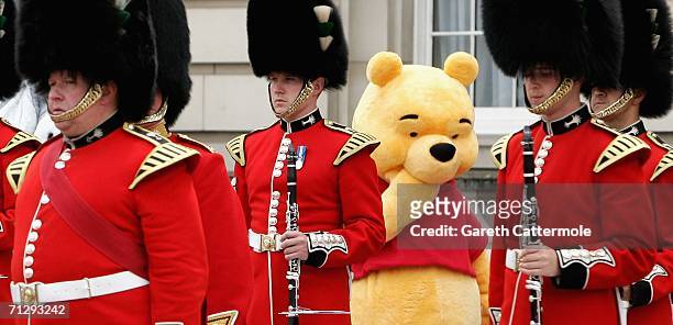 Winnie the pooh wanders around the Forecourt of Buckingham Palace for the Queen's 80th Birthday - Children's Garden Party on June 25, 2006 in London.