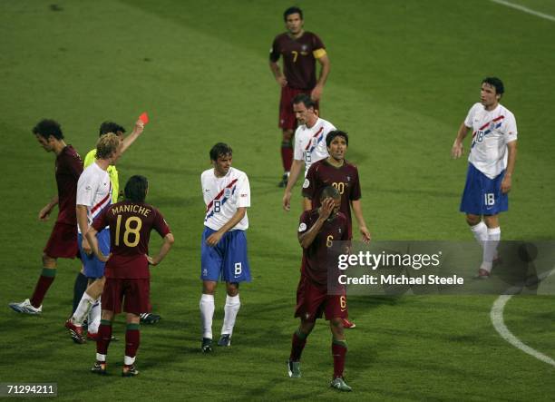 Costinha of Portugal is shown the red card by Referee Valentin Ivanov of Russia, after his second bookable offence in the first half during the FIFA...