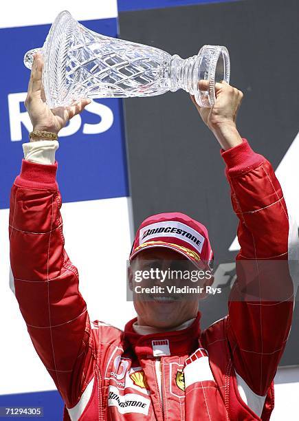 Michael Schumacher of Germany and Ferrari celebrates with the trophy after finishing 2nd during the Canadian Formula One Grand Prix at the...