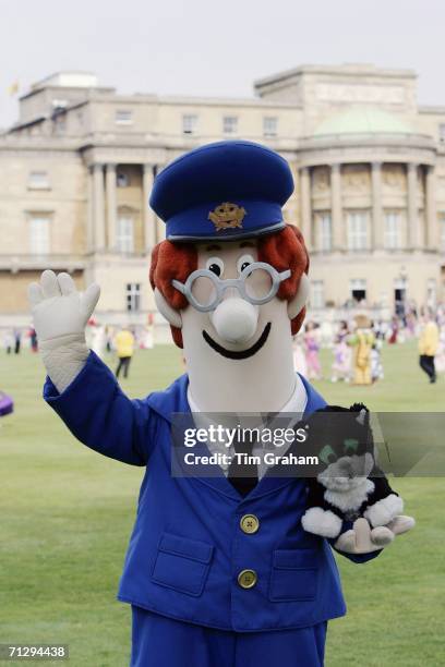 Postman Pat and his Black and White cat, Jess pose at the Children's Party at the Palace, a children's literacy garden party hosted by the Queen to...