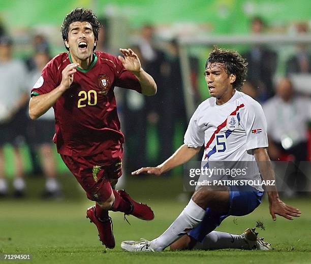 Portuguese midfielder Deco is tackled byDutch defender Giovanni Van Bronckhorst during the World Cup 2006 round of 16 football game Portugal vs....