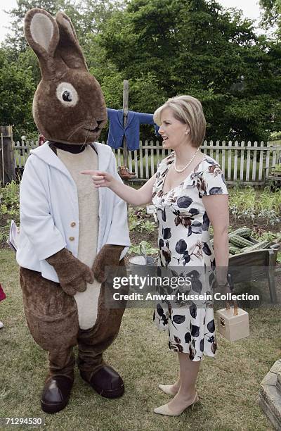 Sophie, Countess of Wessex, stands with Beatrix Potter storybook character Peter Rabbit during a children's party at London's Buckingham Palace on...