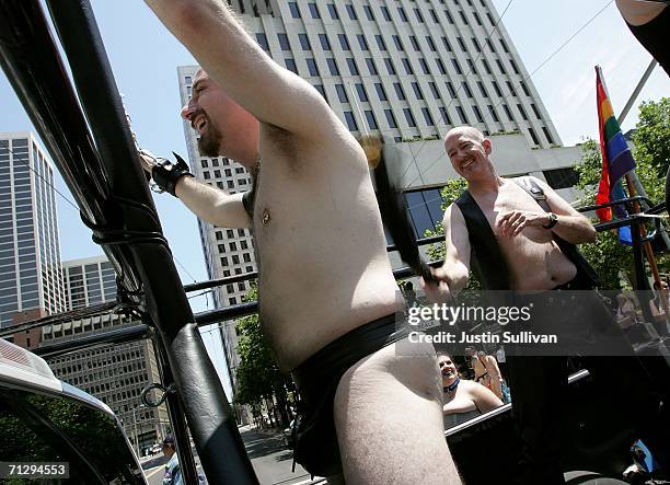 Two men participate in the 36th annual LGBT Pride Parade June 25, 2006 in San Francisco. Hundreds of thousands of spectators lined the street to...