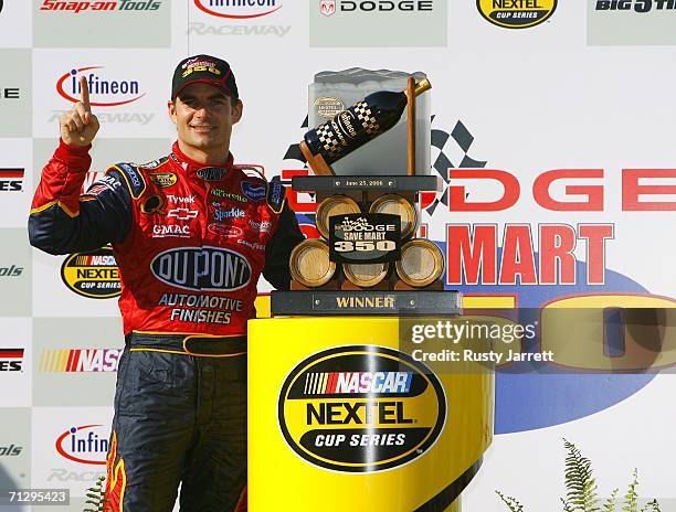 Jeff Gordon, driver of the DuPont Chevrolet poses for photos after winning the NASCAR Nextel Cup Series Dodge/Save Mart 350 at the Infineon Raceway...