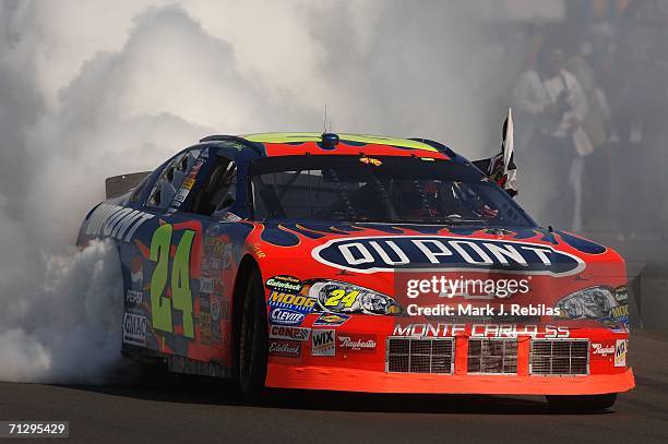 Jeff Gordon, driver of the DuPont Chevrolet, celebrates winning with a burn out after the NASCAR Nextel Cup Series Dodge/Save Mart 350 at the...